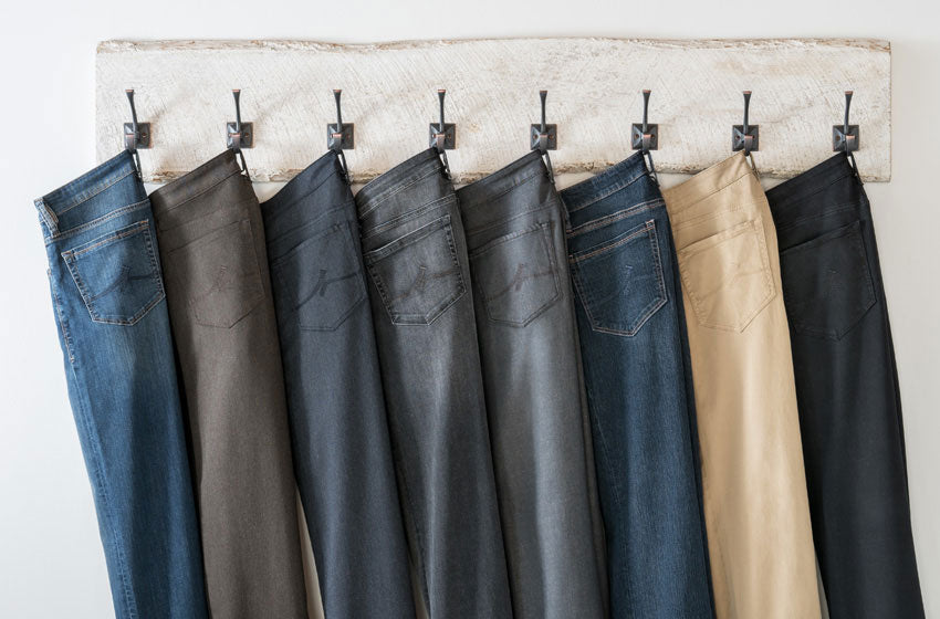 A row of jeans from 34 Heritage hung on a rack